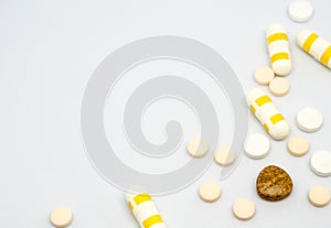 Pill and drug capsule and tablets on white background