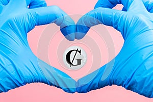 A pill with a Guarani currency sign inside a heart made from hands in medical gloves on a pink background. Rise in the price of