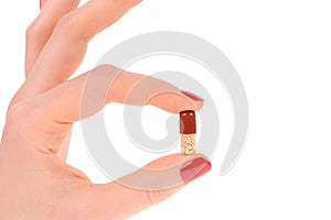 Pill in hand on white background