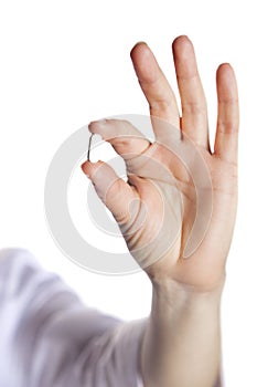 Pill in a hand on a white background close-up