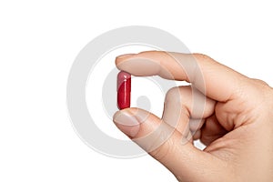 Pill in man`s hand on white background