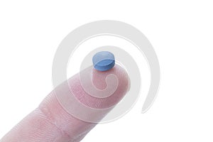 Pill on the tip of a finger