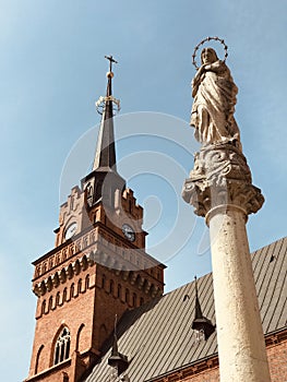 A pillar with a holy saint in front of a Church in the old market square in TarnÃ³w, Poland - POLSKA - CATHOLIC