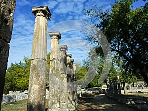 Pillars of marble against the blue sky and cloudsÑŽ Olympia, Peloponnes, Greece