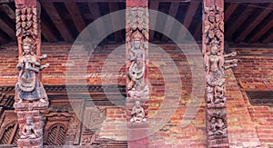 Pillars with religious wood carving in the Sundari Chowk temple in Patan
