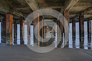 Pillars in the water under the pier, jetty in Blankenberge, Belgium at sunrise