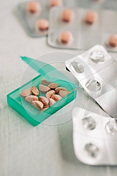 Pillbox with cut pills to take daily dose