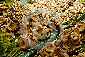 Pilles of Fresh mushrooms on market stall for sale in Chiang Mai local market, Thailand,