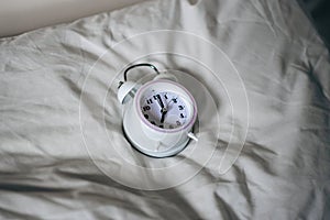 Pillow alarm clock. The concept of sleep problems, insomnia, circadian rhythm
