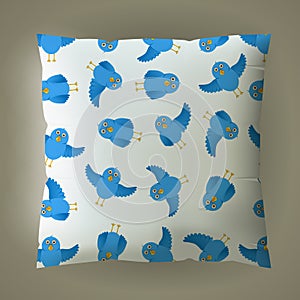 Pillow with blue bird pattern.