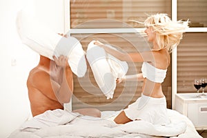 Pillow fight in bedroom