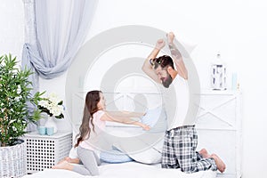 Pillow fight. Dad seeks to live life of integrity and honesty. Sincere emotions. Dad and daughter having fun. Pajamas