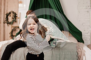 Pillow fight, happy young father and child daughter playing, having fun laughing for funny games, joke and bond together