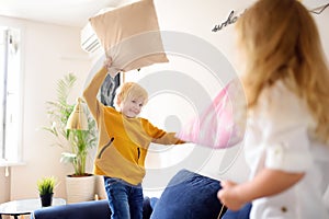 Pillow fight. Brother and sister play together. Active games for siblings at home