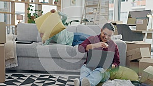 Pillow fight, new home and couple on sofa, smile and bonding in living room, apartment or property. Happy, man and woman
