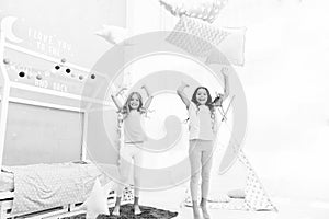 Pillow fight pajama party. Evening time for fun. Sleepover party ideas. Girls happy best friends or siblings in cute