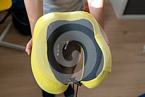 A pillow for sleeping in transport in the hands of a person, a yellow pillow for sleeping with a soft elastic filler to