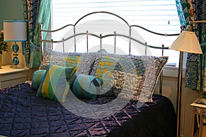 Pillows on Purple Bedspread photo