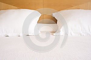 Pillows with white covers on luxury hotel king size bed