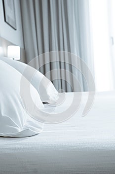 Pillows with white covers on luxury hotel king size bed