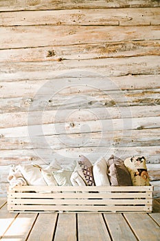 Pillows in a wooden box on the background