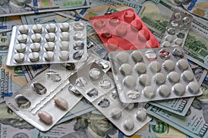 Pills on 100 dollar money. Medicine expenses. High costs of expensive medication concept