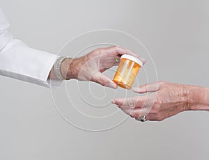 Pills being passed to patient by doctor