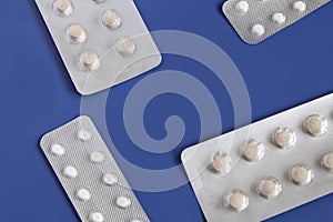 Pills in a blister pack close-up on a blue background.Health and medicine.Pills packing.Medical concept.copyspace for text