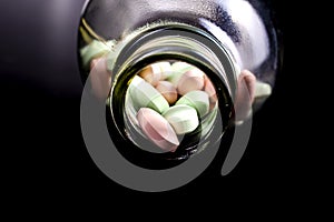 Pills in a bottle black background. Drugs, painkillers, colds and other medicine