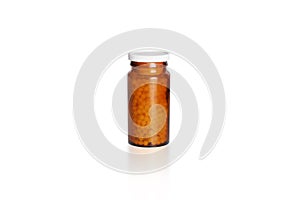 Pills bottle with homeopathic globules isolated on white background. Brown glass medical container for drugs and pills