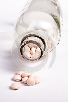 Pills in bottle on white background. Drugs, painkillers, colds other medicines