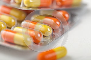 Pills capsule in plastic strip on white background. Antibiotics, vitamins, painkiller