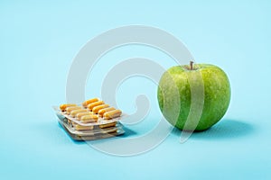 Pills capsules and apples photo