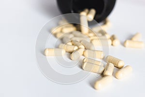 Pills capsules with bottle on white background