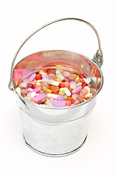 Pills, capsules in a bucket on white background, Pharmacy, Medicine