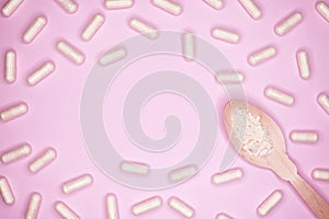 Pills capsules with colostrum, on a pink background