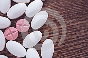 Pills and capsules on dark table, a lot of multicolored medication close-up. Concept of pharmacy, vitamins, health care