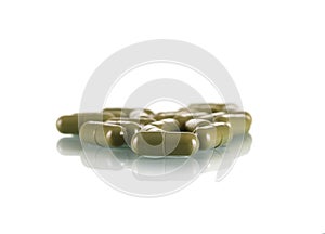 Pills capsules green isolated on white background