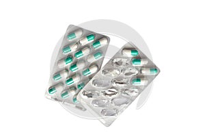Pills capsules in the package isolated on white background. White and green tablets. Full and empty packaging. Concept of health a