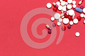 Pills capsules vitamins on pink background flat lay top view copy space. Assorted pharmaceutical products. Medicine, health