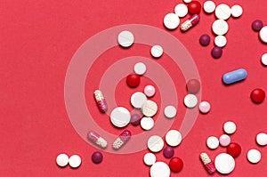 Pills capsules vitamins on pink background flat lay top view copy space. Assorted pharmaceutical products. Medicine, health