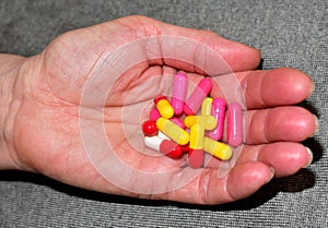 Pills in capsules in woomen hand. Medicine grade pharmaceutical tablets. Medical pill for maintaining and improving health.