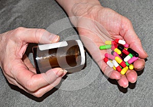 Pills in capsules in woomen hand. Medicine grade pharmaceutical tablets. Medical pill for maintaining and improving health.