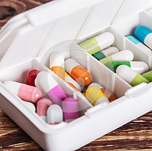 Pills of different colors in a box