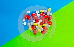 Pills, drugs on green and blue background. Healthcare concept background. Healthcare concept. Shallow depth of field, soft focus