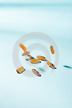 Pills falling down. Gel Capsules. Vitamin A, E, fish oil, primr