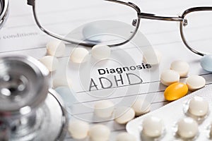 Pills;Glasses And Stethoscope With Text Diagnosis ADHD photo