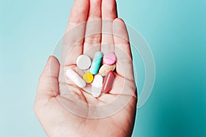 Pills in hand . The concept of health, treatment, disease
