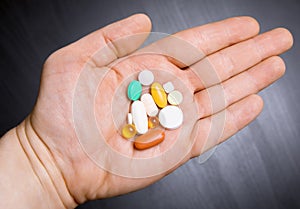 Pills on human hand