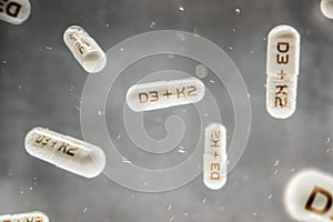 Pills with inscription D3 + K2